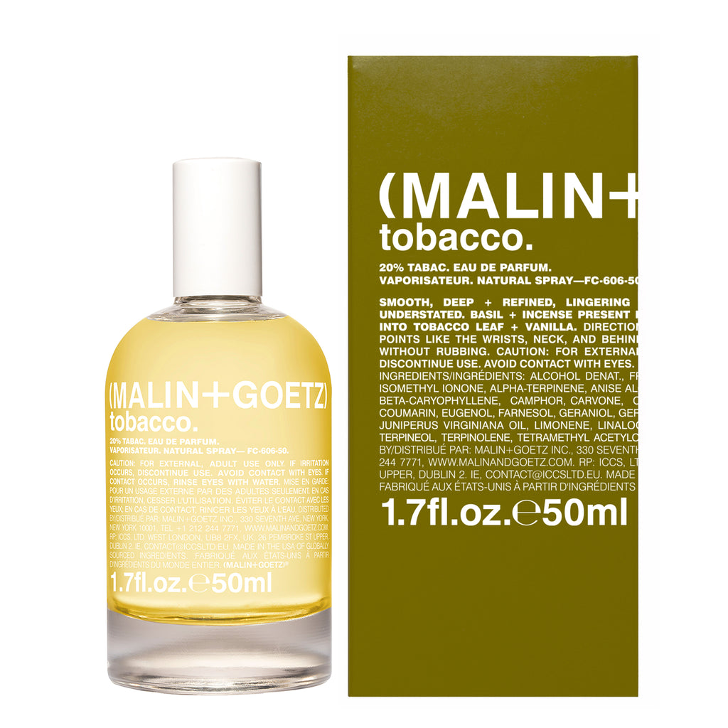 A bottle of Malin + Goetz Tobacco Eau de Parfum next to its olive green outer box, featuring the brand name 'MALIN + TOBACCO' in white text on the packaging.